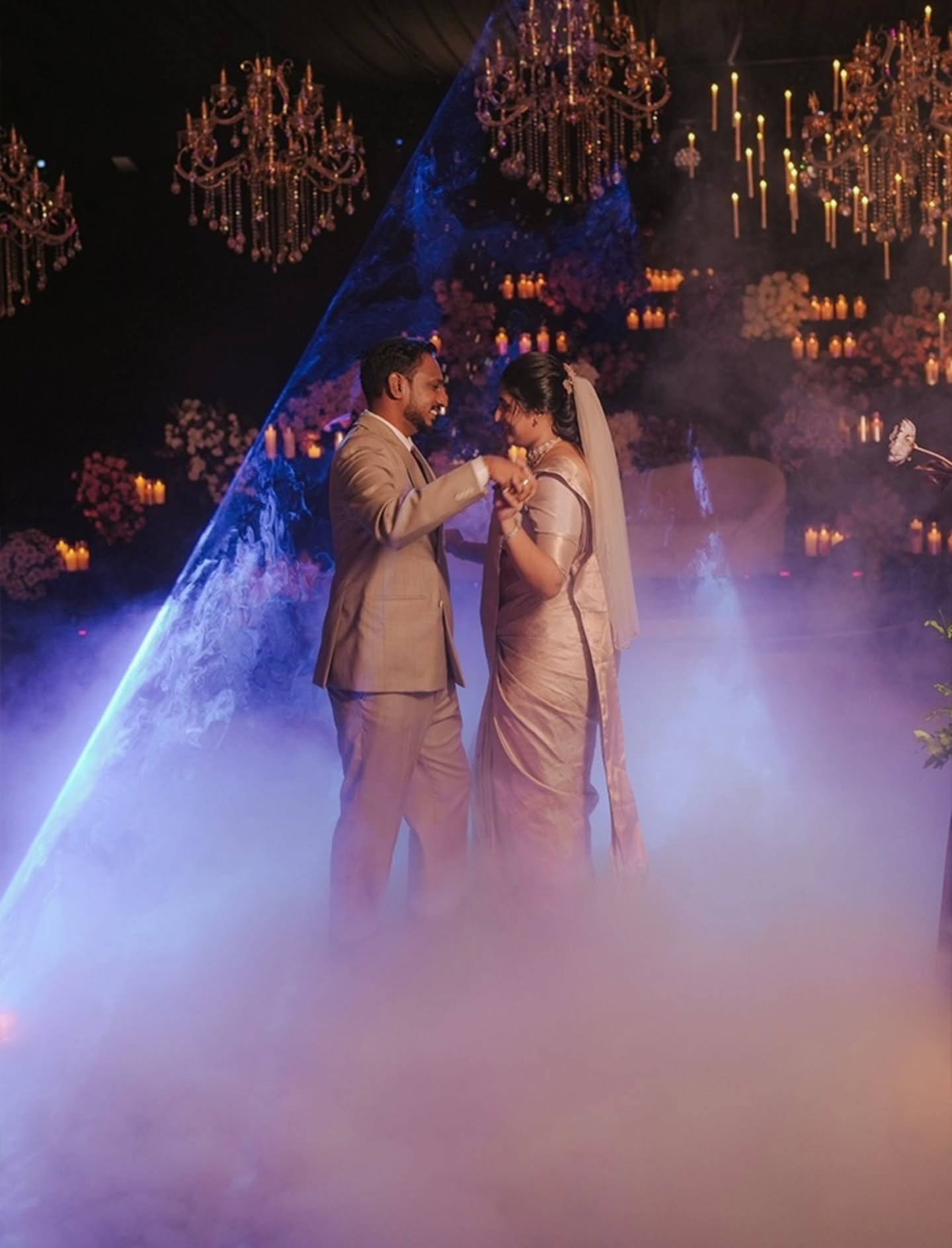 La Decor Events couple portrait beneath chandelier lighting